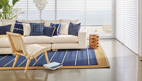 Design your sofa and rug in blues and beiges to create a beach feel with wide windows.